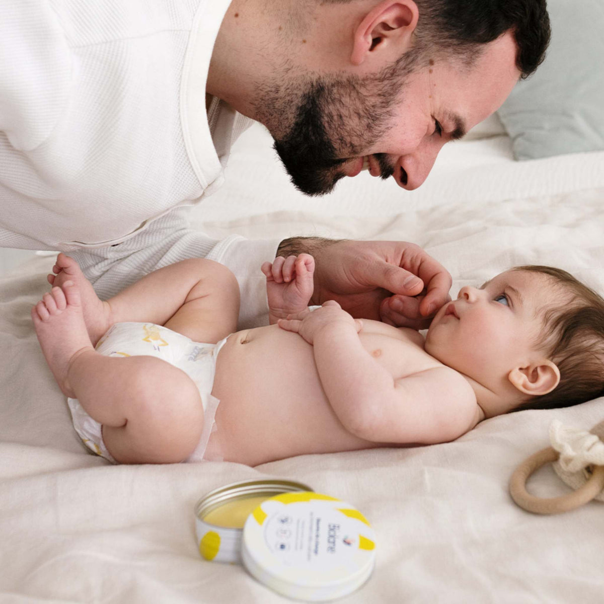 Papa et bébé complices pendant le change, avec le baume de change Biolane